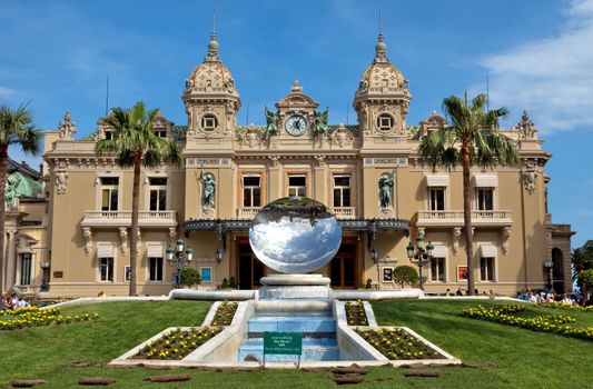 MONTE CARLO, MONACO - JUNE 1, 2014: Front of the Grand Casino. The Casino is one of the most notable buildings in Principality. 

Monte Carlo, Monaco - June 1, 2014: Front of the Grand Casino. The Casino is one of the most notable buildings in Principality. People are walking near a Casino.