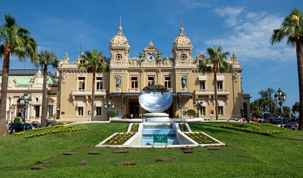 MONTE CARLO, MONACO - JUNE 1: Front of the Grand Casino on June 1, 2014 in Monte Carlo, Monaco. The Casino is one of the most notable buildings in Principality. 

Monte Carlo, Monaco - June 1, 2014: Front of the Grand Casino. The Casino is one of the most notable buildings in Principality. People are walking before and after visiting a Casino.