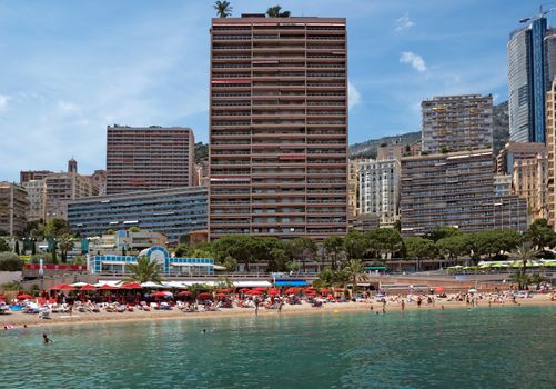 MONTE CARLO, MONACO - JUNE 1, 2014: Architecture of residential buildings from the city beach.

Monte Carlo, Monaco - June 1, 2014: Architecture of residential buildings from the city beach. People are taking a sunbath, sunbathing and swiming.