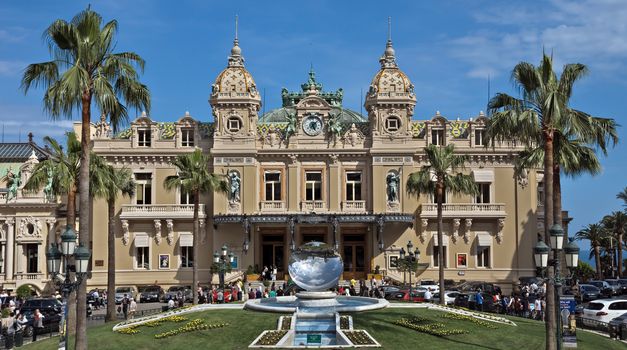MONTE CARLO, MONACO - JUNE 1, 2014: Front of the Grand Casino. The Casino is one of the most notable buildings in Principality. 

Monte Carlo, Monaco - June 1, 2014: Front of the Grand Casino. The Casino is one of the most notable buildings in Principality. People are walking before and after visiting a Casino.