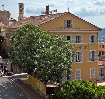 GRASSE, FRANCE - JUNE 2, 2014: Parfumerie Fragonard Factory. Fragonard perfumery is one of the older factory in the world capital of perfumes.

Grasse, France - June 2, 2014: Parfumerie Fragonard Factory. Fragonard perfumery is one of the older factory in the world capital of perfumes. Grasse is a town in the French department of Alpes-Maritimes. City known for its perfume industry. The city was founded in the XI century. People are walking by street.