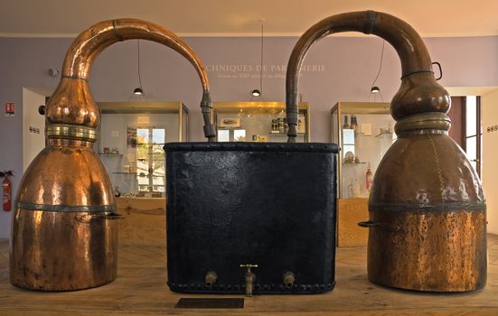 GRASSE, FRANCE - JUNE 2, 2014: Ancient distiller for the production of perfume in Fragonard factory. Fragonard perfumery is one of the older factory in the world capital of perfumes.

Grasse, France - June 2, 2014: Ancient distiller for the production of perfume in Fragonard factory. Fragonard perfumery is one of the older factory in the world capital of perfumes. Grasse is a town in the French department of Alpes-Maritimes. City known for its perfume industry. The city was founded in the XI century.