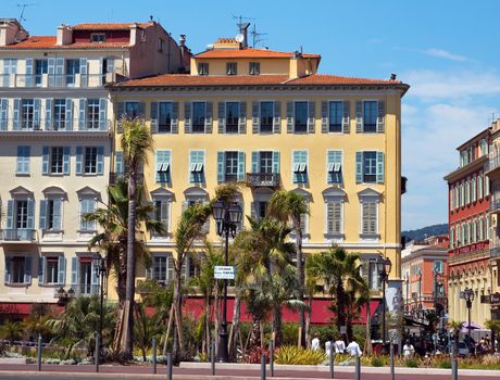 NICE, FRANCE - JUNE 3, 2014: Architecture along Promenade des Anglais. It is a symbol of the Cote d'Azur and was built in 1830 at the expense of the British colony.

Nice, France - June 3, 2014: Architecture along Promenade des Anglais. It is a symbol of the Cote d'Azur and was built in 1830 at the expense of the British colony. People are walking by street.