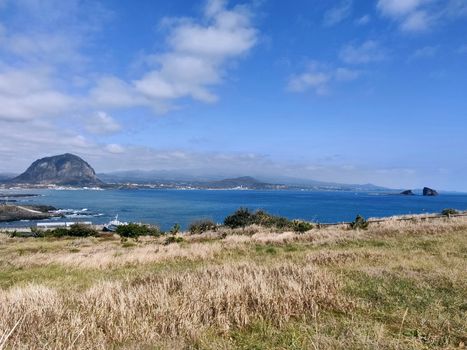 landscape view of Sanbang-san mountain and blue sea from songaksan mountain in Jeju Island, South Korea