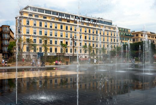 NICE, FRANCE - JUNE 4, 2014: View on the Grand Hotel Aston and Lovely Fountain. Hotel is founded in the early 1930s.

Nice, France - June 4, 2014: View on the Grand Hotel Aston and Lovely Fountain. Hotel is founded in the early 1930s. People are walking near fountain.
