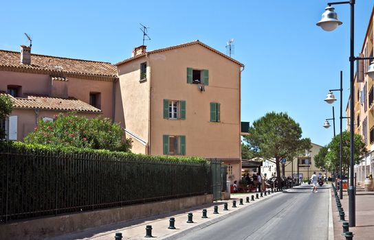 SAINT TROPEZ, FRANCE - JUNE 5, 2014: Architecture of Saint Tropez city in French Riviera, France.

Saint Tropez, France - June 5, 2014: Architecture of Saint Tropez city in French Riviera, France. People are walking by street.