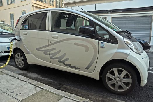NICE, FRANCE - JUNE 2, 2014: Electric cars charging on a street in the city of Nice.

Nice, France - June 2, 2014: Electric cars charging on a street in the city of Nice.