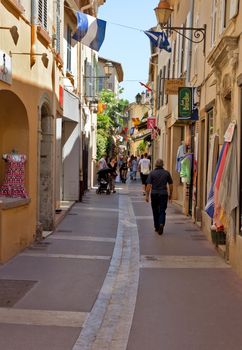 SAINT TROPEZ, FRANCE - JUNE 5, 2014: Streets and architecture of Saint Tropez city in French Riviera, France.

Saint Tropez, France - June 5, 2014: Streets and architecture of Saint Tropez city in French Riviera, France. People are walking by street.