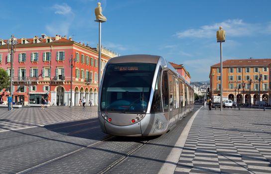 NICE, FRANCE - JUNE 6, 2014: Modern tram in the center of Nice, France. The square was reconstructed in 1979.

Nice, France - June 6, 2014: Modern tram in the center of Nice, France. The square was reconstructed in 1979. People are walking by square.