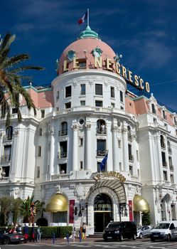 NICE, FRANCE - JUNE 6, 2014: Luxury Hotel Negresco on English Promenade in Nice, French Riviera. Hotel Negresco is the famous luxury hotel on the Promenade des Anglais in Nice.

Nice, France - June 6, 2014: Luxury Hotel Negresco on English Promenade in Nice, French Riviera. Hotel Negresco is the famous luxury hotel on the Promenade des Anglais in Nice, a symbol of the Cote d'Azur. People are standing near the hotel and are on the balconies.
