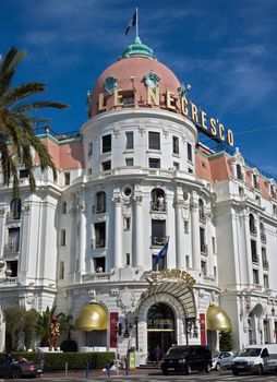 NICE, FRANCE - JUNE 6, 2014: Luxury Hotel Negresco on English Promenade in Nice, French Riviera. Hotel Negresco is the famous luxury hotel on the Promenade des Anglais in Nice.

Nice, France - June 6, 2014: Luxury Hotel Negresco on English Promenade in Nice, French Riviera. Hotel Negresco is the famous luxury hotel on the Promenade des Anglais in Nice, a symbol of the Cote d'Azur. People are standing near the hotel and are on the balconies.