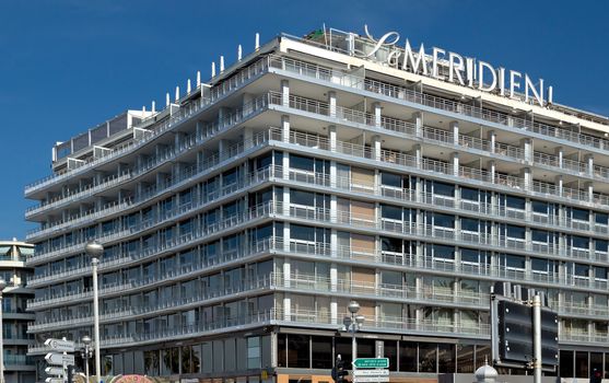 NICE, FRANCE - JUNE 6, 2014: Hotel Le Meridien is located on Promenade des Anglais. Hotel Le Meridien is a symbol of the Cote d'Azur. Built in 1974.

Nice, France - June 6, 2014: Hotel Le Meridien is located on Promenade des Anglais. Hotel Le Meridien is a symbol of the Cote d'Azur. Built in 1974.