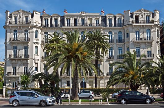 NICE, FRANCE - JUNE 6, 2014: Architecture along Promenade des Anglais. Promenade des Anglais is a symbol of the Cote d'Azur and was built in 1830 at the expense of the British colony.

Nice, France - June 6, 2014: Architecture along Promenade des Anglais. Promenade des Anglais is a symbol of the Cote d'Azur and was built in 1830 at the expense of the British colony.