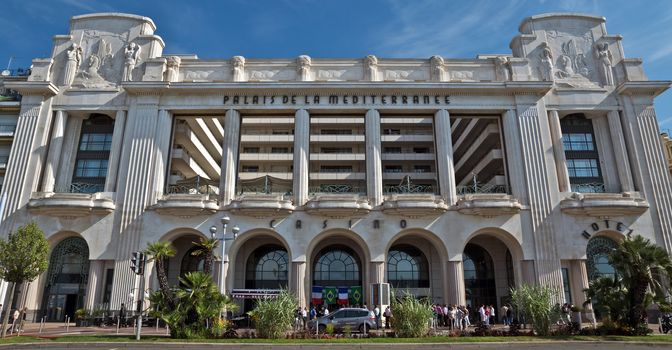 NICE, FRANCE - JUNE 6, 2014: Mediterranean Palace is located on the Promenade des Anglais. This hotel was built in 1930 by architect Charles Dalma.

Nice, France - June 6, 2014: Mediterranean Palace is located on the Promenade des Anglais. This hotel was built in 1930 by architect Charles Dalma. People are standing near hotel.
