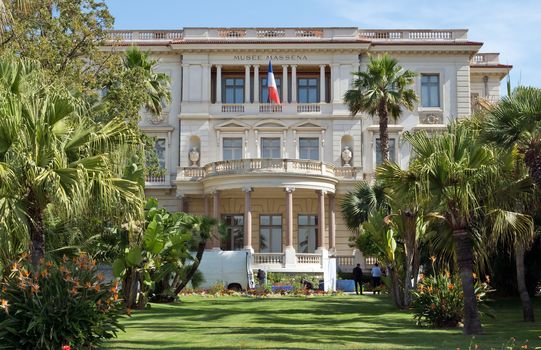 NICE, FRANCE - JUNE 6, 2014: The Massena Palace Museum of Art and History. It is one of the main sights along Promenade des Anglais. 

Nice, France - June 6, 2014: The Massena Palace Museum of Art and History. It is one of the main sights along Promenade des Anglais. People are standing in the garden.