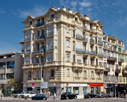 NICE, FRANCE - JUNE 4, 2014: Architecture along Promenade des Anglais. Promenade des Anglais is a symbol of the Cote d'Azur and was built in 1830 at the expense of the British colony.

Nice, France - June 4, 2014: Architecture along Promenade des Anglais. Promenade des Anglais is a symbol of the Cote d'Azur and was built in 1830 at the expense of the British colony. People are walking by street.