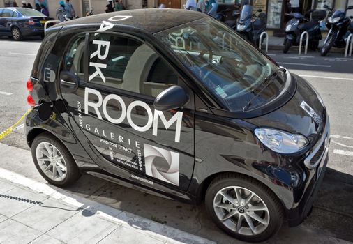 NICE, FRANCE - JUNE 6, 2014: Smart electric drive cars charging at on-street stations.

Nice, France - June 6, 2014: Smart electric drive cars charging at on-street stations. Electric car charging on a street in the center of Nice.
