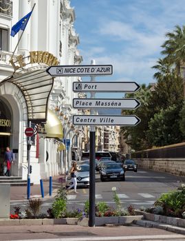 NICE, FRANCE - JUNE 6, 2014: Road signpost against luxury Hotel Negresco in Nice, French Riviera.

Nice, France - June 6, 2014: Road signpost against luxury Hotel Negresco in Nice, French Riviera. Hotel Negresco is the famous luxury hotel on the Promenade des Anglais in Nice, a symbol of the Cote d'Azur. People are walking by street.