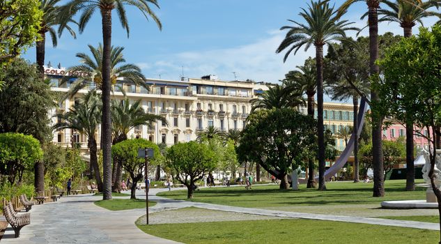 NICE, FRANCE - JUNE 6, 2014: Garden of Albert I next to the famous Massena Place. 

Nice, France - June 6, 2014: Garden of Albert I next to the famous Massena Place. People are resting and are walking in the garden.