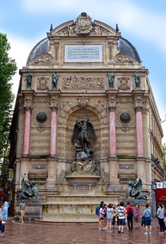 PARIS, FRANCE - JUNE 9: Fountain Saint-Michel at Place Saint-Michel on June 9, 2014 in Paris, France. It was constructed in 1858-1860 during French Second Empire by architect Gabriel Davioud.

Paris, France - June 9, 2014: Fountain Saint-Michel at Place Saint-Michel. It was constructed in 1858-1860 during French Second Empire by architect Gabriel Davioud. Tourists are visiting the landmark.