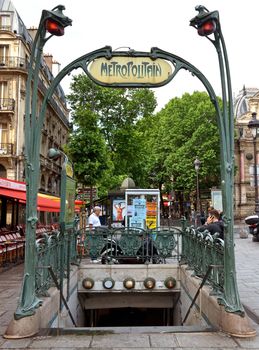 PARIS, FRANCE - JUNE 9: Entrance to the subway, in the style of Art Deco on June 9, 2014 in Paris, France. 

Paris, France - June 9, 2014: Entrance to the subway, in the style of Art Deco. People are standing near entrance to subway.