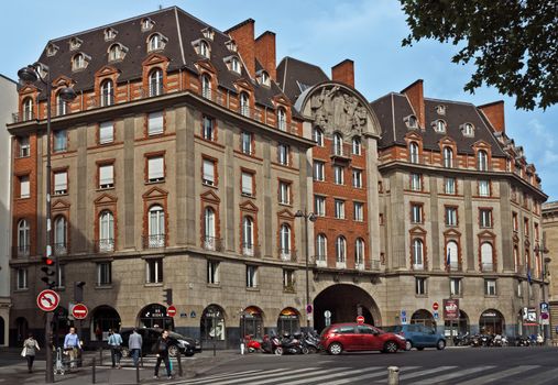 PARIS, FRANCE - JUNE 9, 2014: View of the typical french architecture on the Left Bank district.

Paris, France - June 9, 2014: View of the typical french architecture on the Left Bank district. People are walking by street.