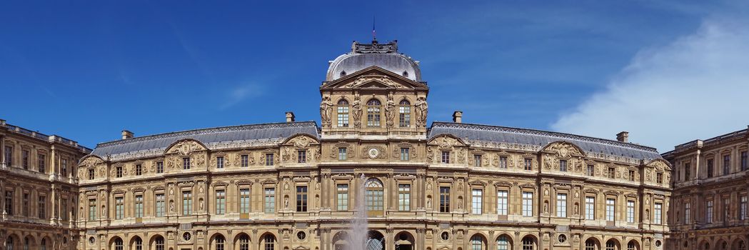 PARIS, FRANCE - JUNE 9: The Louvre Museum facade on June 9, 2014 in Paris, France. Louvre is one of the biggest Museum in the world, receiving more than 8 million visitors each year. 

Paris, France - June 9, 2014: The Louvre Museum facade. Louvre is one of the biggest Museum in the world, receiving more than 8 million visitors each year.