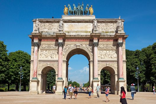 PARIS, FRANCE - JUNE 9: Triumphal Arch (Arc de Triomphe du Carrousel) at Tuileries gardens on June 9, 2014 in Paris, France. Monument was built between 1806-1808 to commemorate Napoleon's military victories.

Paris, France - June 9, 2014: Triumphal Arch (Arc de Triomphe du Carrousel) at Tuileries gardens in Paris, France. Monument was built between 1806-1808 to commemorate Napoleon's military victories. People are walking through and near Arch.