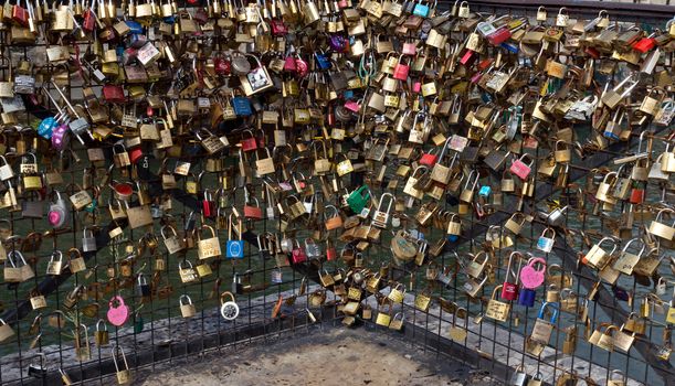 PARIS, FRANCE - JUNE 9, 2014: Love Padlocks at Pont des Arts over the river Seine. The thousands of locks of loving couples symbolize love forever. It is the narrowest road bridge in Paris and it was built in 1828.

Paris, France - June 9, 2014: Love Padlocks at Pont des Arts over the river Seine. The thousands of locks of loving couples symbolize love forever. It is the narrowest road bridge in Paris and it was built in 1828.