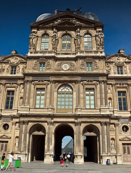 PARIS, FRANCE - JUNE 9, 2014: The Louvre Museum. Louvre is one of the biggest Museum in the world, receiving more than 8 million visitors each year.

Paris, France - June 9, 2014: The Louvre Museum. Louvre is one of the biggest Museum in the world, receiving more than 8 million visitors each year. People are entering the museum.