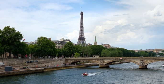 A view of the Eiffel Tower with a bridge in the foreground. Paris, France.
