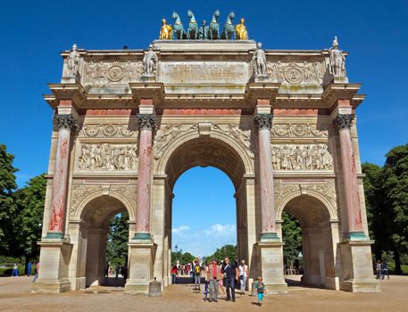 PARIS, FRANCE - JUNE 9: Triumphal Arch (Arc de Triomphe du Carrousel) at Tuileries gardens. Monument was built between 1806-1808 to commemorate Napoleon's military victories.

Paris, France - June 9, 2014: Triumphal Arch (Arc de Triomphe du Carrousel) at Tuileries gardens in Paris, France. Monument was built between 1806-1808 to commemorate Napoleon's military victories. People are walking through Arch.