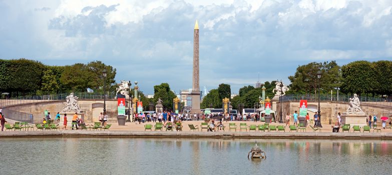 PARIS, FRANCE - JUNE 9: The Tuileries Gardens and Park in Paris, with a view of the Egyptian Obelisk at the Place de la Concorde on June 9, 2014 in Paris, France. Tuileries Garden is a public garden located between the Louvre Museum and the Place de la Concorde.

Paris, France - June 9, 2014: The Tuileries Gardens and Park in Paris, with a view of the Egyptian Obelisk at the Place de la Concorde. Tuileries Garden (Jardin des Tuileries) is a public garden located between the Louvre Museum and the Place de la Concorde. People are resting.