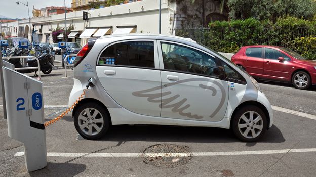 NICE, FRANCE - JUNE 6, 2014: Smart electric drive cars charging at on-street stations.

Nice, France - June 6, 2014: Smart electric drive cars charging at on-street stations. Electric car charging on a street in the center of Nice.