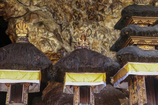 Altars at Pura Goa Lawah or Bat Cave Temple. Balinese Hindu temple in Pesinggahan, Klungkung, Bali, Indonesia. Many bats hanging from the ceiling of the Cave of bats. Colony of bats are waiting dark.