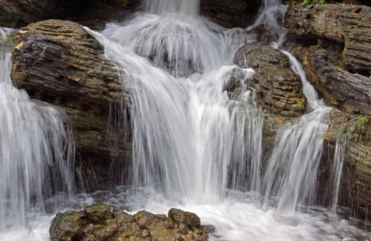 Small waterfall in a mountain forest in the morning.