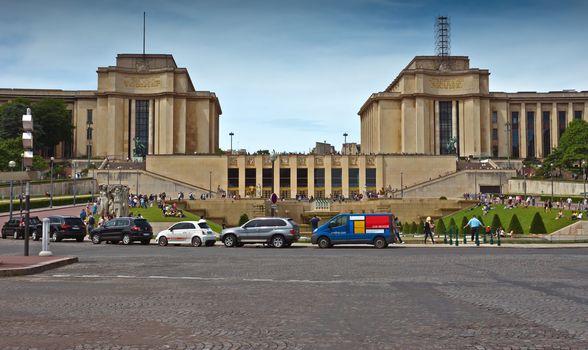 PARIS, FRANCE - JUNE 9, 2014: Palace - Palais de Chaillot. Was built in 1937 on a Hill of Trocadero.

Paris, France - June 9, 2014: Palace - Palais de Chaillot. Was built in 1937 on a Hill of Trocadero. People are walking on outdoors and are resting on a grass.
