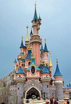 Paris, France - June 10, 2014: Sleeping Beauty Castle in Disneyland park. Disneyland Paris one of Europe's most popular attraction. People go to the castle.