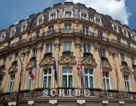 PARIS, FRANCE - JUNE 11, 2014: Building of the Hotel Scribe. Located in the Opera district, close to Place Vendome, pl. Madeleine and pl. Consent, in a beautiful historic building, where in 1895 the Lumiere brothers invented cinema.

Paris, France - June 11, 2014: Building of the Hotel Scribe. Located in the Opera district, close to Place Vendome, pl. Madeleine and pl. Consent, in a beautiful historic building, where in 1895 the Lumiere brothers invented cinema.