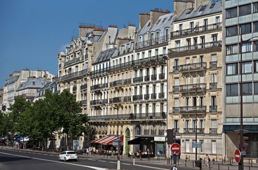 PARIS, FRANCE - JUNE 11, 2014: View of the parisian architecture.

Paris, France - June 11, 2014: View of the parisian architecture. People are walking by street.