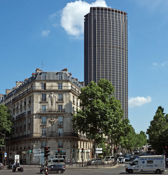 PARIS, FRANCE - JUNE 11, 2014: The architecture of the old and modern Paris. View of old building and Tour Montparnasse. Tour Montparnasse was constructed 1969 - 1972 by architects Eugene Beaudouin, Urbain Cassan and Louis Hoym de Marien.

Paris, France - June 11, 2014: The architecture of the old and modern Paris. View of old building and Tour Montparnasse. Tour Montparnasse was constructed 1969 - 1972 by architects Eugene Beaudouin, Urbain Cassan and Louis Hoym de Marien. People are walking by street.
