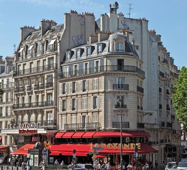 PARIS, FRANCE - JUNE 11, 2014: View of the parisian architecture.

Paris, France - June 11, 2014: View of the parisian architecture. People are walking by street.
