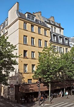 PARIS, FRANCE - JUNE 11, 2014: View of the parisian architecture on the Left Bank.

Paris, France - June 11, 2014: View of the parisian architecture on the Left Bank. People are resting and are walking by street.