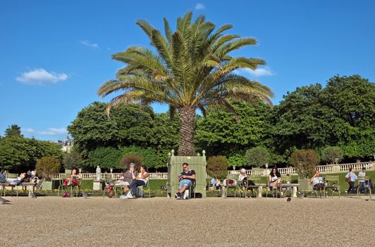 PARIS, FRANCE - JUNE 11, 2014: The Jardin du Luxembourg. Many people are resting there.

Paris, France - June 11, 2014: The Jardin du Luxembourg. Many people are resting there.
