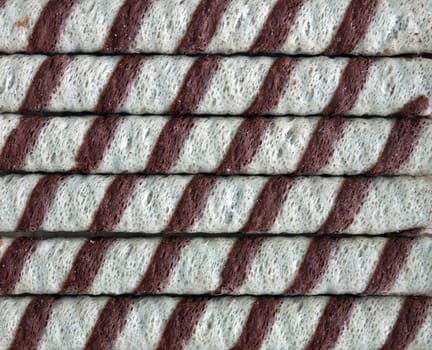 A closeup of chocolate striped wafer rolls