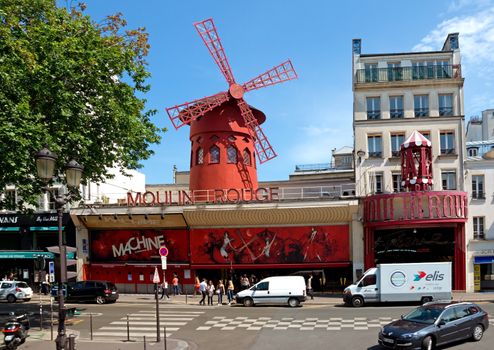 
PARIS - JUNE 11: The Moulin Rouge during the day on June 11, 2014 in Paris, France. Moulin Rouge is a famous cabaret built in 1889, locating in the Paris red-light district of Pigalle.

Paris, France - June 11, 2014: The Moulin Rouge during the day. Moulin Rouge is the most famous Parisian cabaret and it created the modern can-can dance. Built in 1889, locating in the Paris red-light district of Pigalle. People stand near the cabaret.