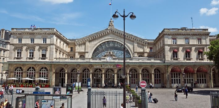 PARIS, FRANCE - JUNE 11, 2014: Gare de L'Est - one of the six large SNCF terminal in Paris, largest and oldest railway stations in Paris. 

Paris, France - June 11, 2014: Gare de L'Est - one of the six large SNCF terminal in Paris, largest and oldest railway stations in Paris. Travelers and pedestrians in front of the station.