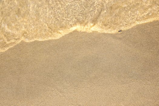 Golden sand and wave of tropical sea background