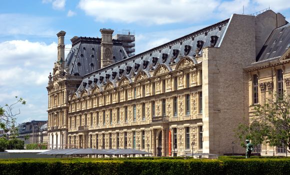 PARIS, FRANCE - JUNE 11: The Louvre Museum on June 11, 2014 in Paris, France. Louvre is one of the biggest Museum in the world, receiving more than 8 million visitors each year. 

Paris, France - June 11, 2014: The Louvre Museum. Louvre is one of the biggest Museum in the world, receiving more than 8 million visitors each year.