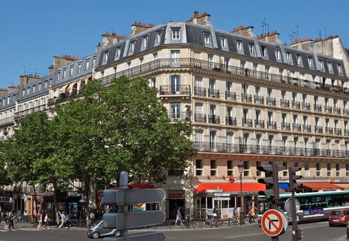 PARIS, FRANCE - JUNE 11, 2014: View of the parisian architecture.

Paris, France - June 11, 2014: View of the parisian architecture. People are walking by street.